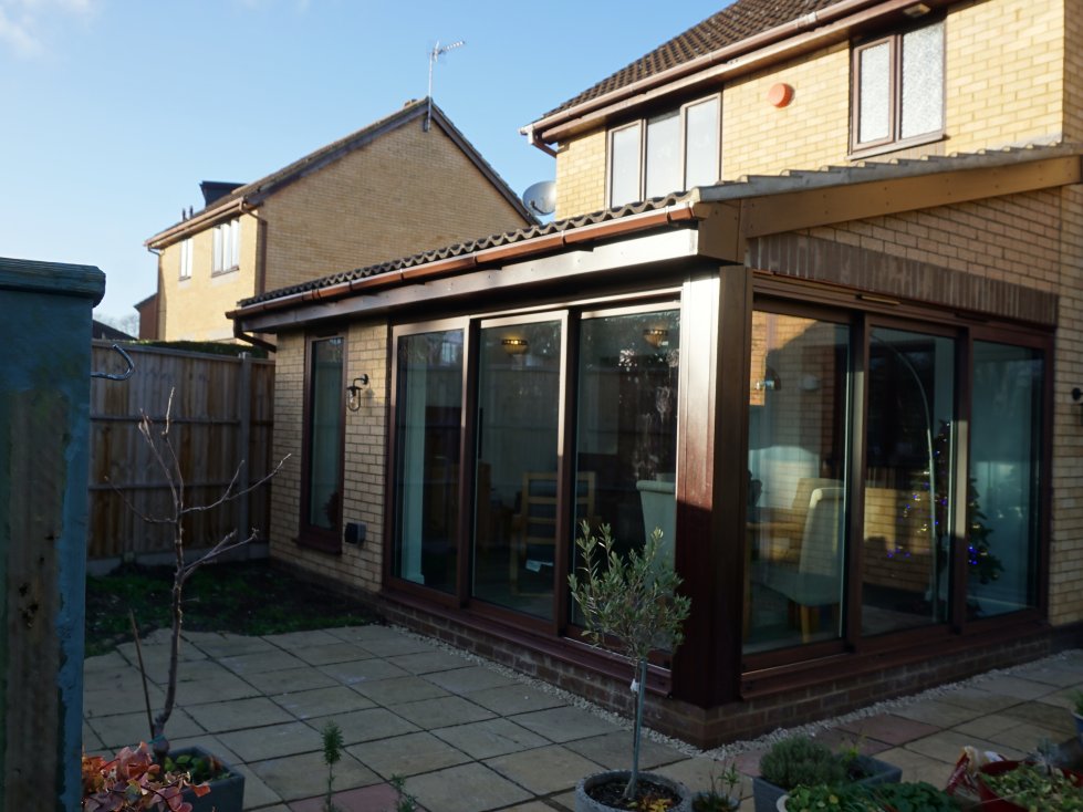 Contemporary home extension featuring wood effect aluminium sliding doors and tilt turn windows