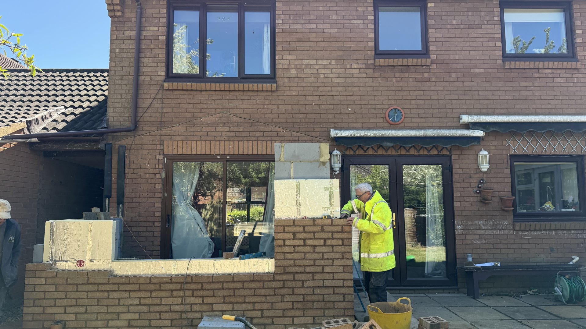 Homeowner reviewing home extension plans with builder in Milton Keynes — Crownhill Building Services consultation